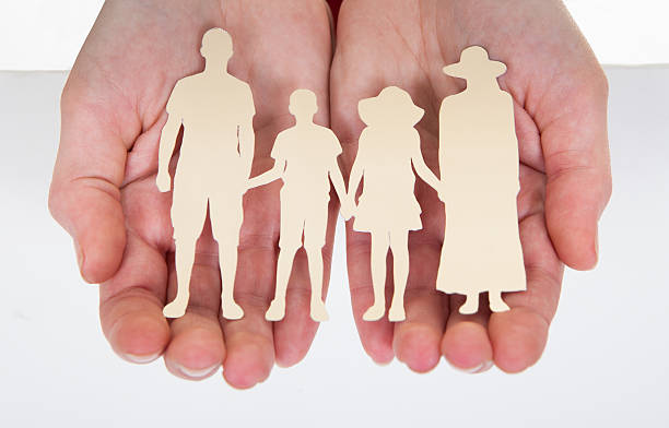 istock Male Hand Holding Family Cutout Shape 184044604
