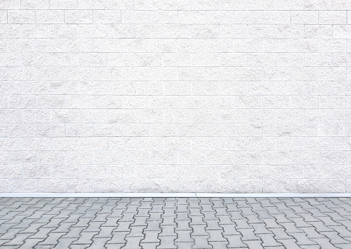 Modern white brick wall texture background with a sidewalk