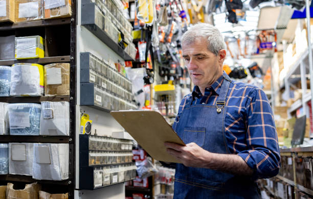istock Retail clerk working at a hardware store taking inventory 1840466256