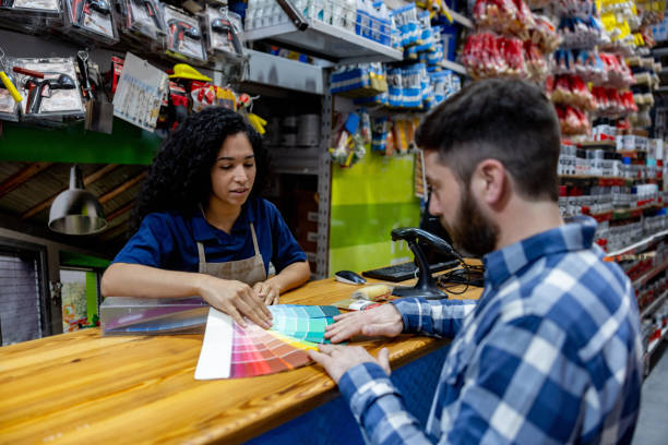 istock Man buying paint at a hardware store and looking at a color chart 1840467372