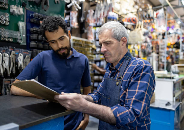 istock Business owner training a new hire at a hardware store 1840467906