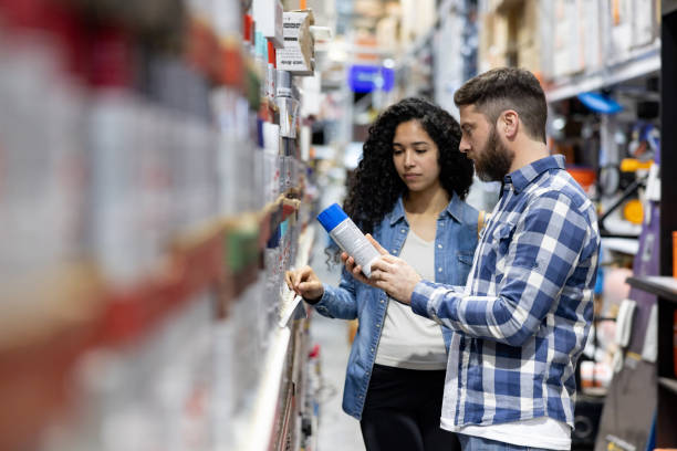 Couple shopping for spray paint at a hardware store