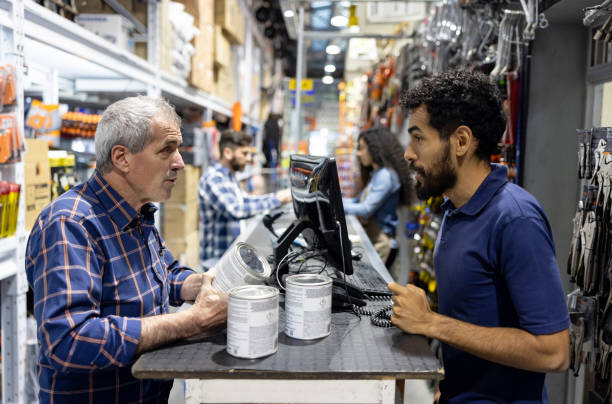 istock Retail clerk serving a customer buying paint at a hardware store 1840467940