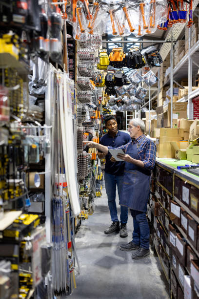 istock Business manager training a new worker at a hardware store 1840468413
