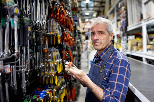 istock Salesman working at a hardware store and holding a wrench 1840468474