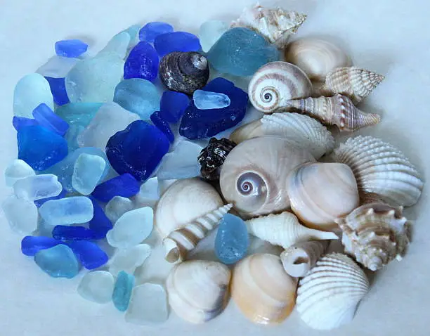 Yin Yang symbol created from seashells and blue seaglass