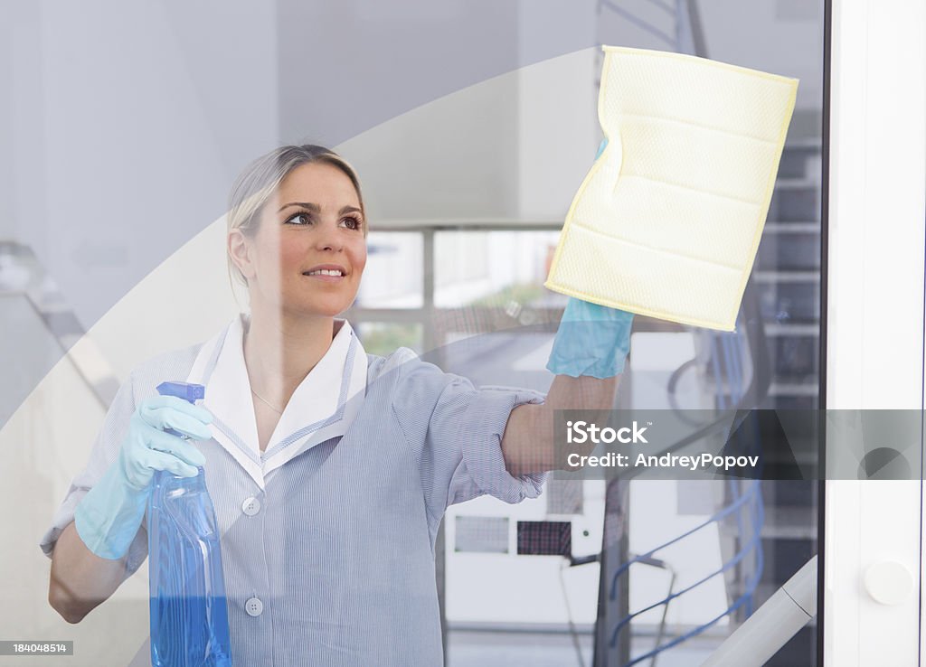 Young Maid With Bottle And Sponge Young Happy Maid Holding Bottle And Cloth Cleaning Stock Photo