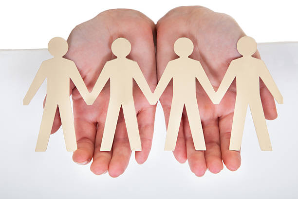 istock Male Hand Holding Human Figure Cutout 184049108