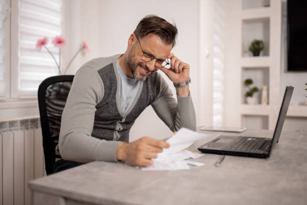 istock Mid Adult Man Struggling with Debt 1840498012