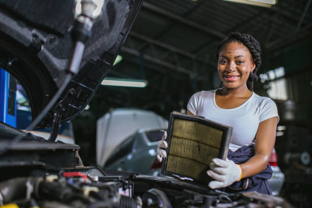 istock Mechanic is checking and change an air filter. Car mechanic working maintenance checking air filter in repair garage. 1840506318