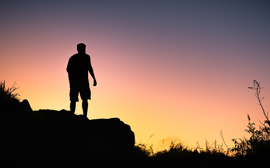 Man hiking at sunrise.