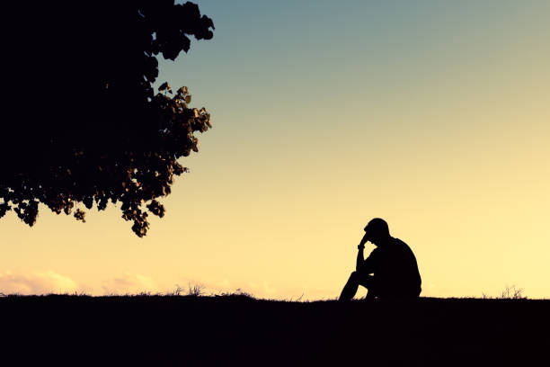 istock Sad lonely men sitting in the beach park. 1840517415