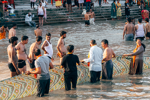 haridwar, india. 15th september, 2023: people are doing purification ceremony in ganges river at haridwar