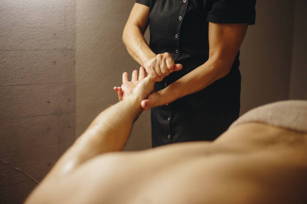 Unrecognizable man receiving massage stock photo