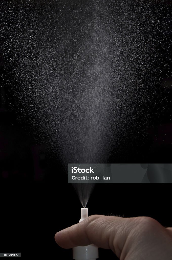 Nasal spray spraying Fingers squeezing on a bottle of nasal spray Sneezing Stock Photo