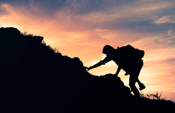 istock Male hiker climbing mountains at sunset. 1840551251
