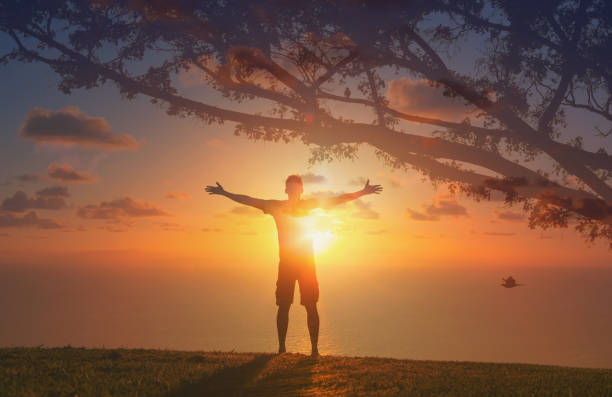istock Happy men standing in the sunset. 1840559870