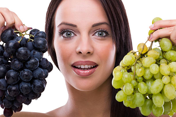 istock young beautiful woman holding grapes 184056732
