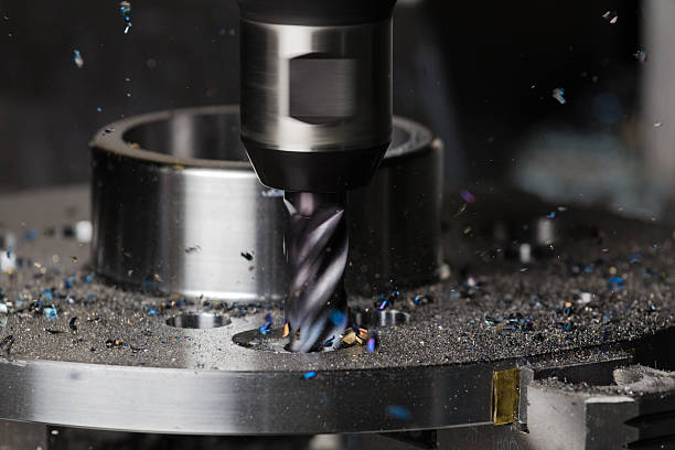 Milling Action A hole is milled in a flange on a CNC machining center using a carbide endmill machining stock pictures, royalty-free photos & images