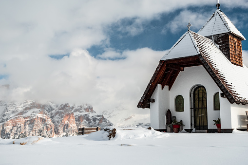 An old church on the top of the mountain in italian alps during winter season