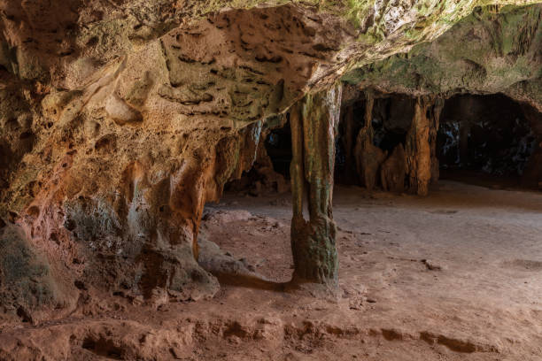 istock Stone columns in Quadiriki cave, Aruba. Multi-colored. Open cavern in background. 1840581528