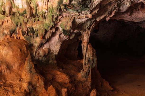 istock Stone columns in Quadiriki cave, Aruba. Multi-colored. Open cavern in background. 1840581956