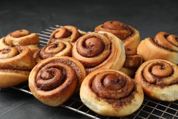 istock Tasty cinnamon rolls on black table, closeup 1840592218
