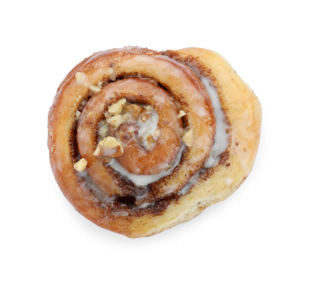 istock One tasty cinnamon roll with nuts isolated on white, top view 1840592327