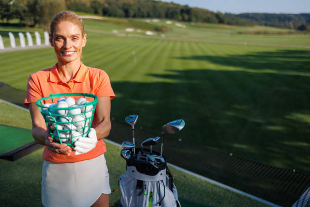 istock Sporty Female Golfer Retrieving Golf Balls 1840593928