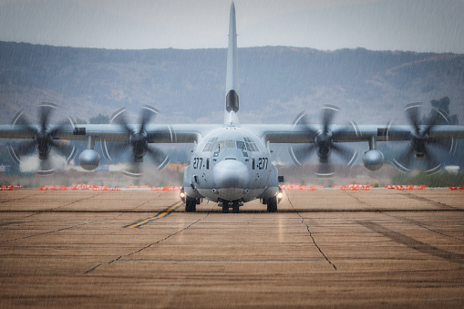 Miramar, California, USA - September 22, 2023: A C-130 Hercules stands in the rain on the tarmac at America's Airshow 2023.