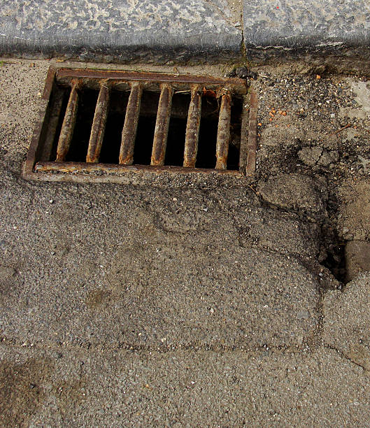 istock close view of a worn road with rusty sewer 184060550