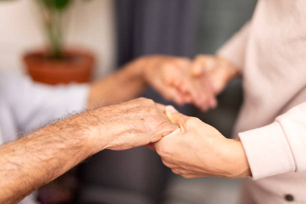istock Close up hands of helping hands elderly home care. 1840612994