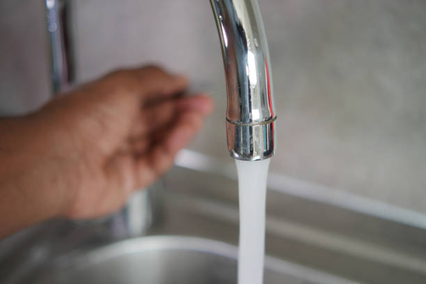 istock water pouring from a faucet tap slow motion 1840622901