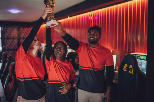 istock Professional eSports Team Celebrating Victory With Trophy 1840664416