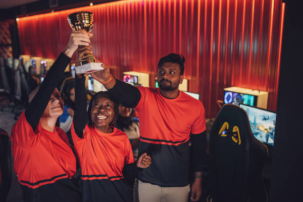 istock Professional eSports Team Celebrating Victory With Trophy 1840665992