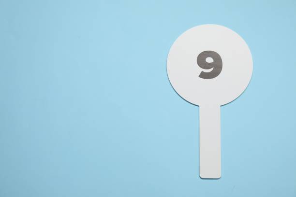 istock Auction paddle with number 9 on light blue background, top view. Space for text 1840676053