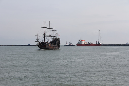 Gdynia, Port, Poland. A cruise galleon sailing into the harbor with tourists.