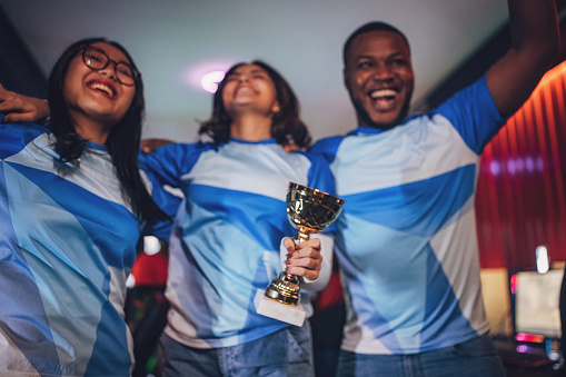 Professional eSports Team Celebrating Victory With trophy after winning tournament