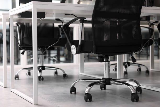 istock Comfortable office chairs and tables in meeting room, closeup 1840697782