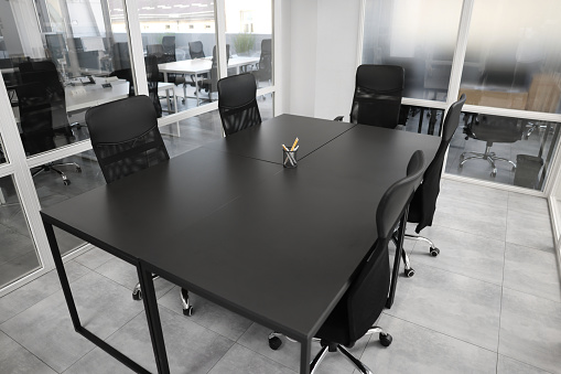 Comfortable office chairs and tables in meeting room