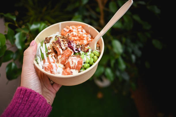 istock Human hand with fresh poke with salmon. 1840713619