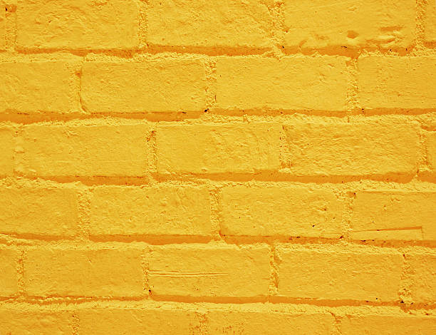 istock Vibrant yellow brick wall as a background 184073923