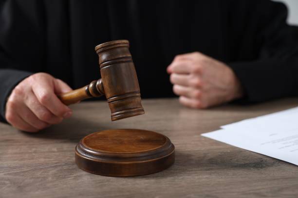 istock Judge with gavel and papers at wooden table, closeup 1840746571
