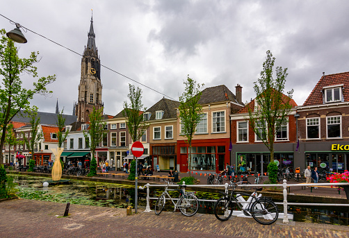 Delft, Netherlands - June 2018: Delft canals and New church tower