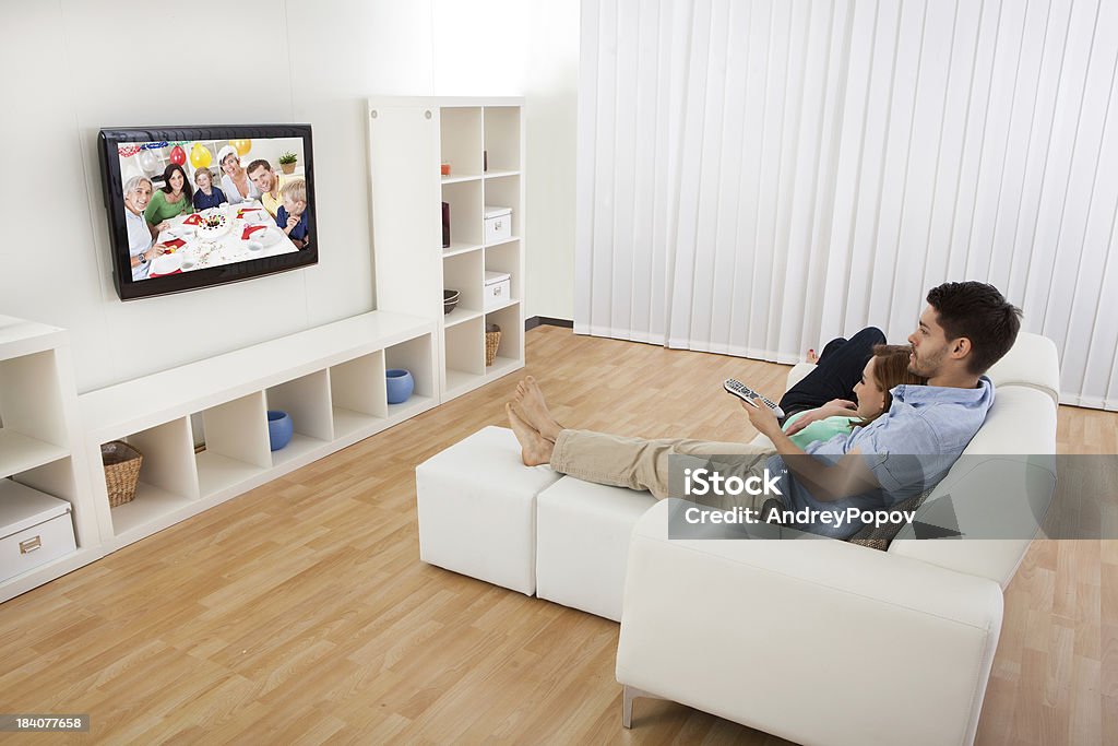 Young couple using laptop Portrait of young couple using laptop lying on bed Adult Stock Photo