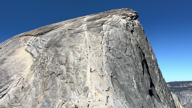 The backside of Half Dome in Yosemite National Park with the cable climbing system