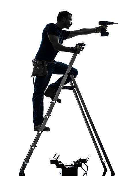 istock manual worker man on stepladder drilling silhouette 184079927