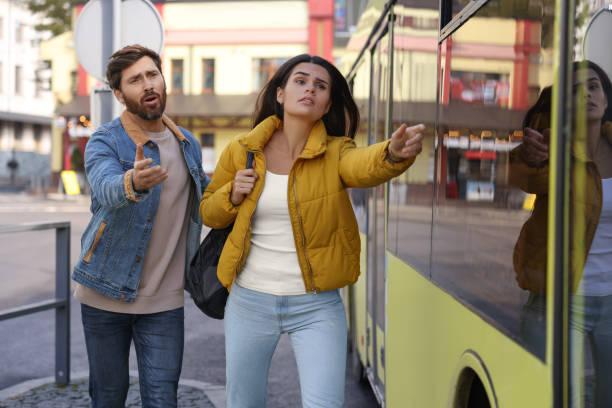 Being late. Worried couple running towards bus outdoors, space for text