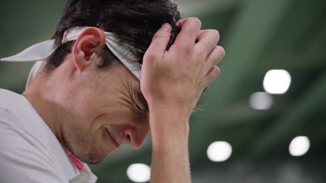 SLO MO Male tennis player disappointed after failing