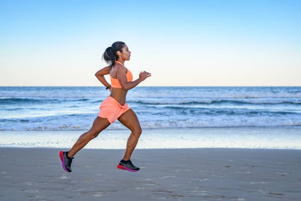 istock Woman athlete running on the beach 1840852991